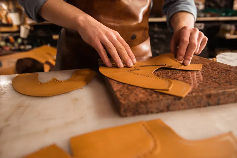 close-up-shoemaker-measuring-leather